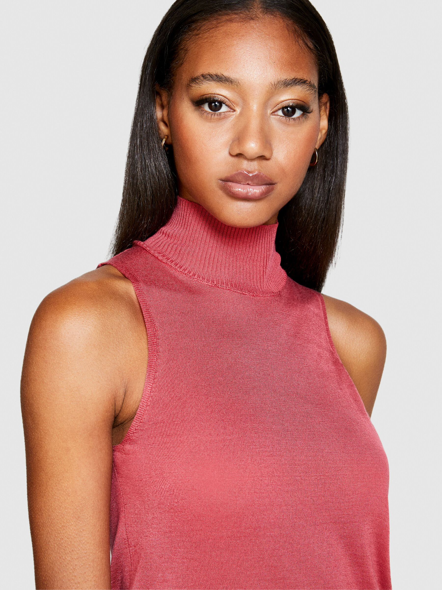 Pink sleeveless turtleneck top